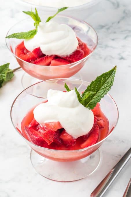Soaked strawberries with whipped cream and fresh mint.