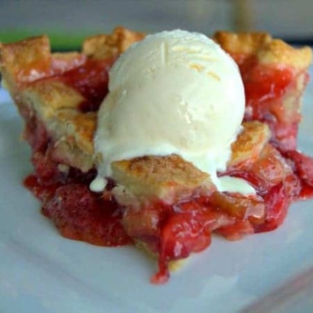 A lattice topped pie filled with a deliciously tart, yet sweet strawberry rhubarb filling accentuated with orange zest .