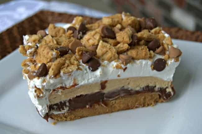 Crushed peanut butter sandwich cookies topped with layers of chocolate pudding, cream cheese and peanut butter and Cool Whip.