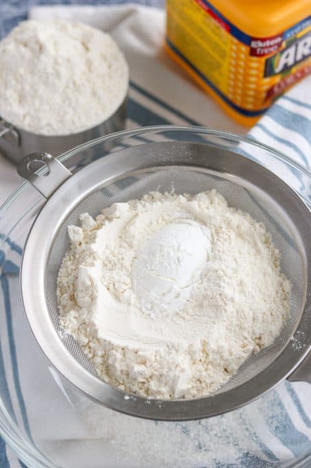 Flour and corn starch in a fine mesh sieve.