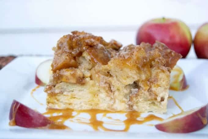 A taste of Fall with this baked French toast, apples, caramel sauce, and a cinnamon streusel topping - mornings at the table will never be the same!