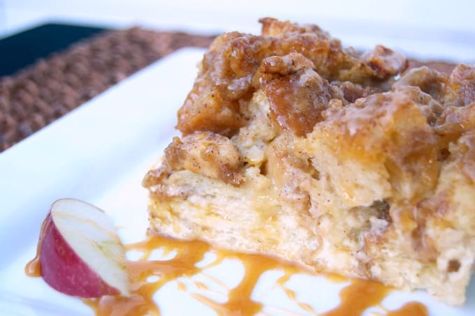 A taste of Fall with this baked French toast, apples, caramel sauce, and a cinnamon streusel topping - mornings at the table will never be the same!