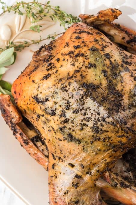 A roasted turkey with fresh herbs.