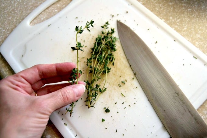 Removing fresh herbs like rosemary and thyme from their stems is easy with this little trick!