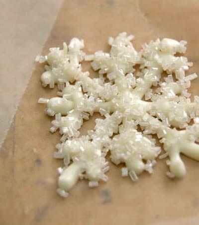 Melted white chocolate piped into the shape of a snowflake and sprinkled with shimmer white sugar. These make adorable cupcake and cake toppers!