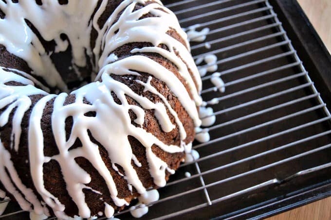 A moist delicious banana bundt cake filled with mini chocolate chips and drizzled with a cream cheese frosting!