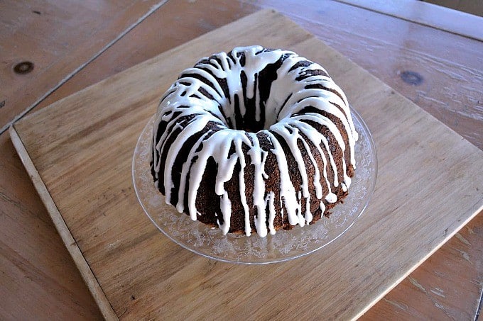 A moist delicious banana bundt cake filled with mini chocolate chips and drizzled with a cream cheese frosting!