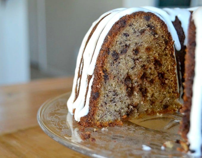 A moist delicious banana bundt cake filled with mini chocolate chips and drizzled with a cream cheese frosting!