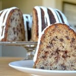 A moist delicious banana bundt cake filled with mini chocolate chips and drizzled with a cream cheese frosting!