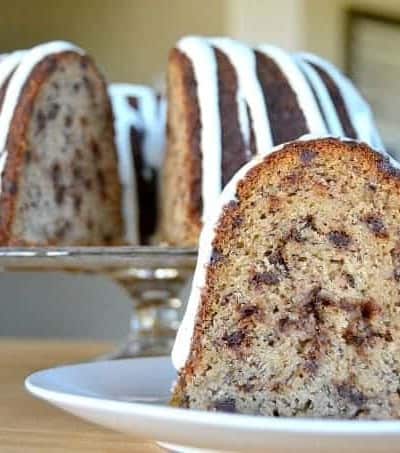 A moist delicious banana bundt cake filled with mini chocolate chips and drizzled with a cream cheese frosting!