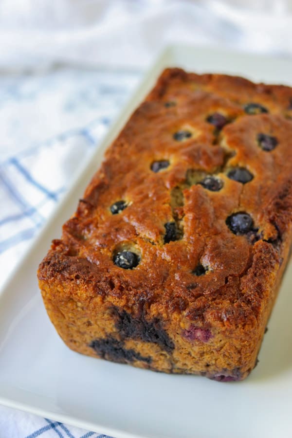 A loaf of banana bread with blueberries in it.