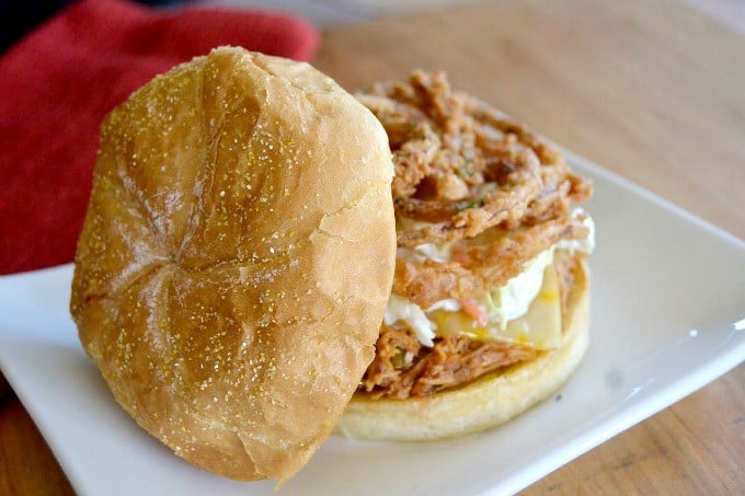 Shredded, slow cooked, barbecue chicken on a Cobblestone Bread Co. Corn Dusted Kaiser Roll topped with melted cheese, cole slaw and onion strings!