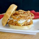 Shredded, slow cooked, barbecue chicken on a Cobblestone Bread Co. Corn Dusted Kaiser Roll topped with melted cheese, cole slaw and onion strings!