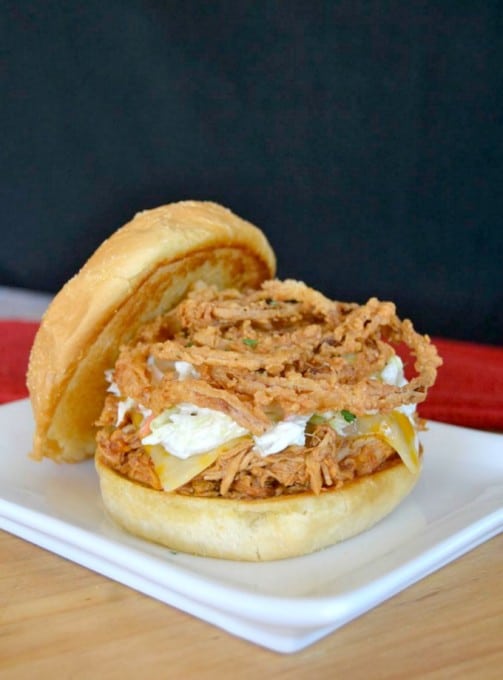 Shredded, slow cooked, barbecue chicken on a Cobblestone Bread Co. Corn Dusted Kaiser Roll topped with melted cheese, cole slaw and onion strings!