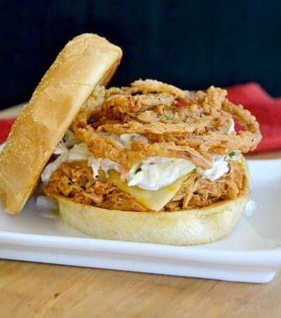 Shredded, slow cooked, barbecue chicken on a Cobblestone Bread Co. Corn Dusted Kaiser Roll topped with melted cheese, cole slaw and onion strings!