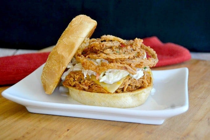 Shredded, slow cooked, barbecue chicken on a Cobblestone Bread Co. Corn Dusted Kaiser Roll topped with melted cheese, cole slaw and onion strings!