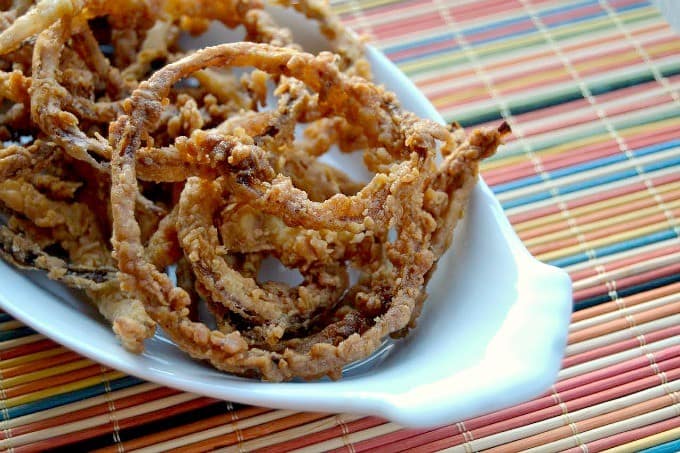 Thin slices of onion, soaked in buttermilk dipped in a spiced flour and fried to perfection.