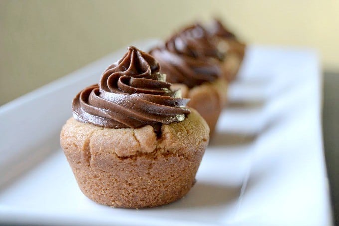 Peanut Butter Cookie Cups stuffed with a mini Reese's and topped with chocolate buttercream!