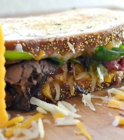Layers of Wisconsin cheddar and gouda cheeses, caramelized onions, plum chutney and roast beef make up this incredible grilled cheese sandwich!