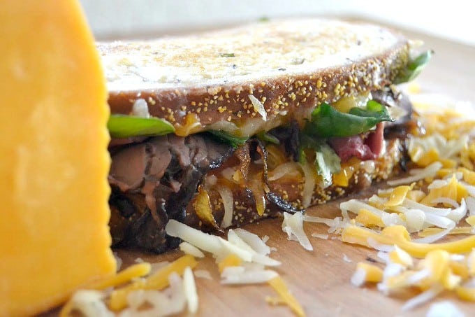 Layers of Wisconsin cheddar and gouda cheeses, caramelized onions, plum chutney and roast beef make up this incredible grilled cheese sandwich!