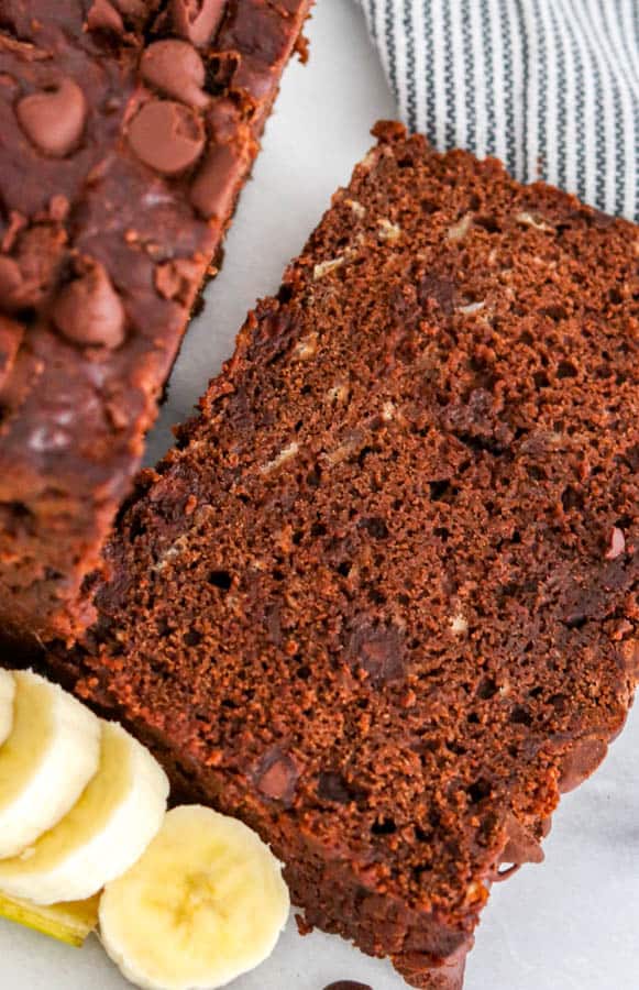 A slice of Double Chocolate Banana Bread next to slices of banana.