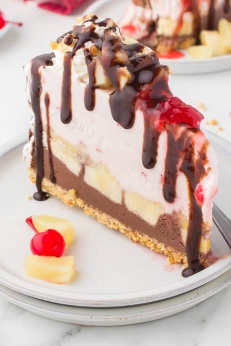 A slice of an ice cream cake that tastes like a banana split.