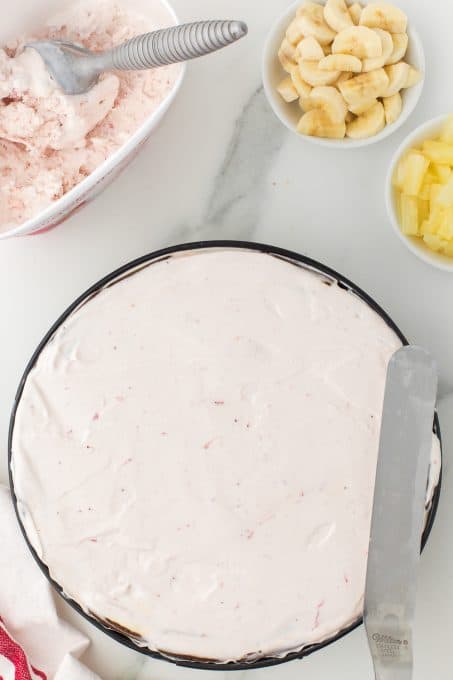 Strawberry ice cream layer of a frozen banana split cake.