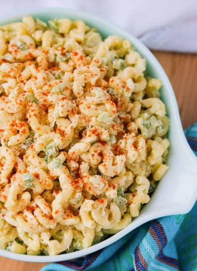 A bowl full of salad made with elbow macaroni.