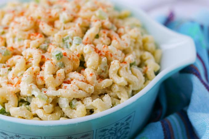 Elbow macaroni, green pepper, onion, celery, mayo, mustard, and white vinegar in a salad.