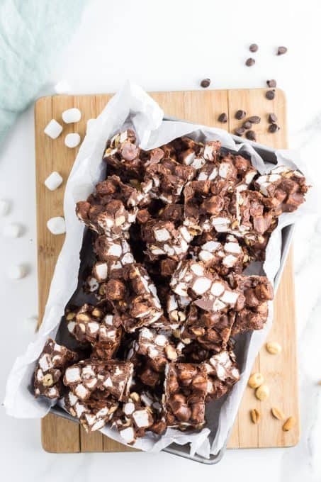 A tray of chocolate peanut butter fudge with peanuts and marshmallows.