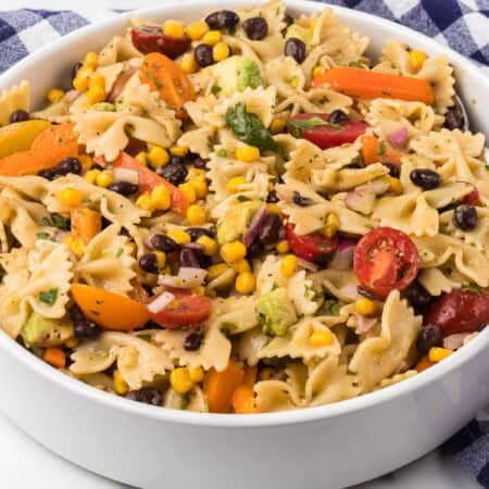 A cold salad with vegetables, black beans and pasta.