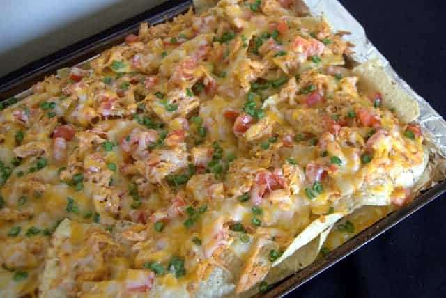 Nachos loaded with BBQ Chicken, tomatoes, green onions and lots of cheese!
