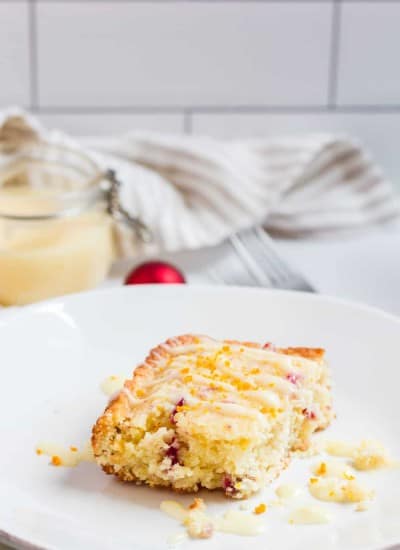 A slice of coffee cake made with orange juice and zest, and chopped cranberries.