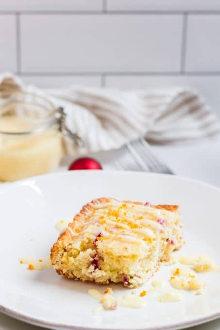 A slice of coffee cake made with orange juice and zest, and chopped cranberries.