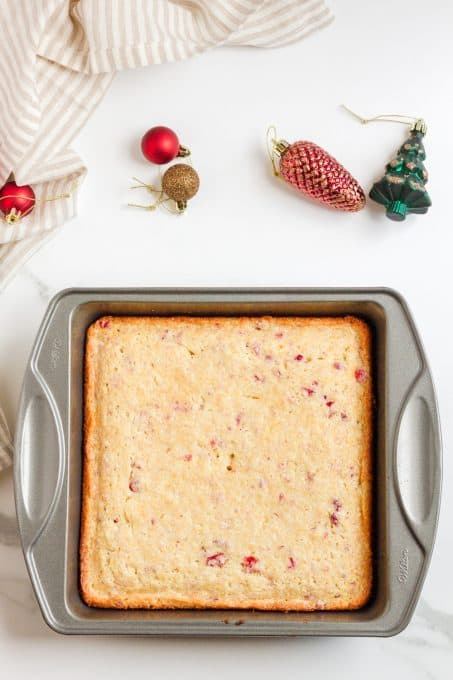 A baked orange coffee cake with cranberries.