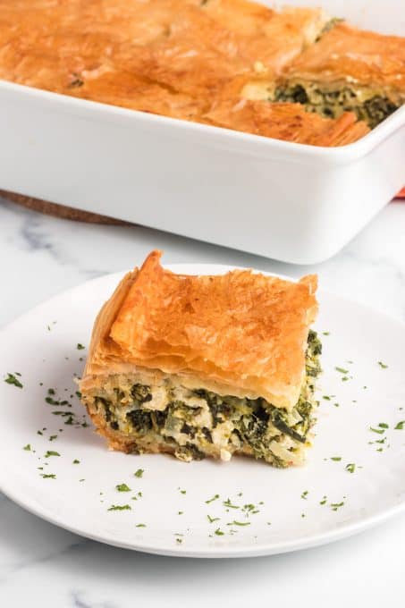 A slice of Greek spinach pie on a plate.