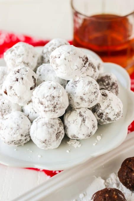 A plate of bourbon balls made with pecans and cocoa.