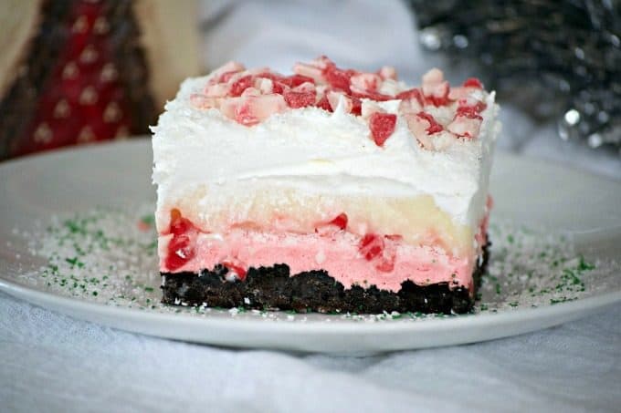 Peppermint Dream Dessert - an Oreo crust, a creamy peppermint layer, white chocolate pudding, crunchy peppermint baking chips and shaved white chocolate make this a fabulous holiday treat!