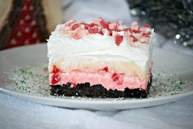 Peppermint Dream Dessert - an Oreo crust, a creamy peppermint layer, white chocolate pudding, crunchy peppermint baking chips and shaved white chocolate make this a fabulous holiday treat!