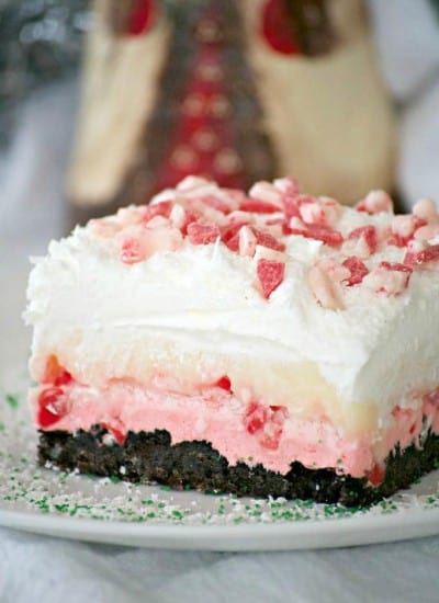 Peppermint Dream Dessert - an Oreo crust, a creamy peppermint layer, white chocolate pudding, crunchy peppermint baking chips and shaved white chocolate make this a fabulous holiday treat!