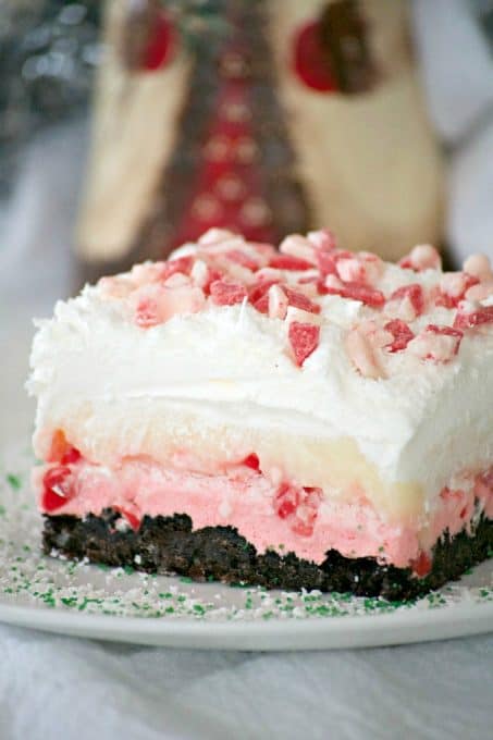 Peppermint Dream Dessert - an Oreo crust, a creamy peppermint layer, white chocolate pudding, crunchy peppermint baking chips and shaved white chocolate make this a fabulous holiday treat!