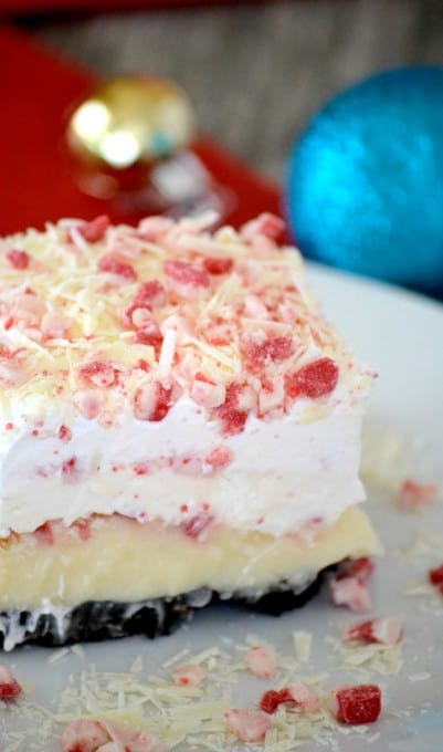 Peppermint Dream Dessert - an Oreo crust, cheesecake pudding, a creamy peppermint layer, crunchy peppermint baking chips and white chocolate make this a fabulous holiday treat!