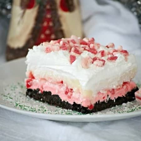 Peppermint Dream Dessert - an Oreo crust, a creamy peppermint layer, white chocolate pudding, crunchy peppermint baking chips and shaved white chocolate make this a fabulous holiday treat!