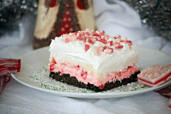 Peppermint Dream Dessert - an Oreo crust, a creamy peppermint layer, white chocolate pudding, crunchy peppermint baking chips and shaved white chocolate make this a fabulous holiday treat!