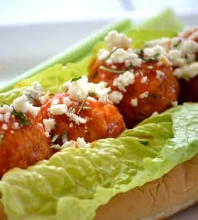 These Buffalo Chicken Meatballs made with ground chicken, buffalo sauce and Panko bread crumbs are perfect as a Game Day appetizer or in a roll topped with your choice of blue cheese or ranch dressing!