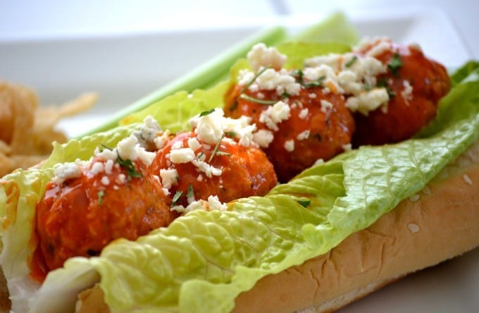 These Buffalo Chicken Meatballs made with ground chicken, buffalo sauce and Panko bread crumbs are perfect as a Game Day appetizer or in a roll topped with your choice of blue cheese or ranch dressing!