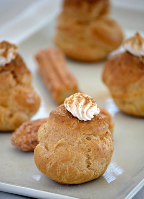 These Churro Cream Puffs are a simple Pâte à Choux filled with a sweetened cinnamon whipped cream and sprinkled with some cinnamon sugar to top it off.