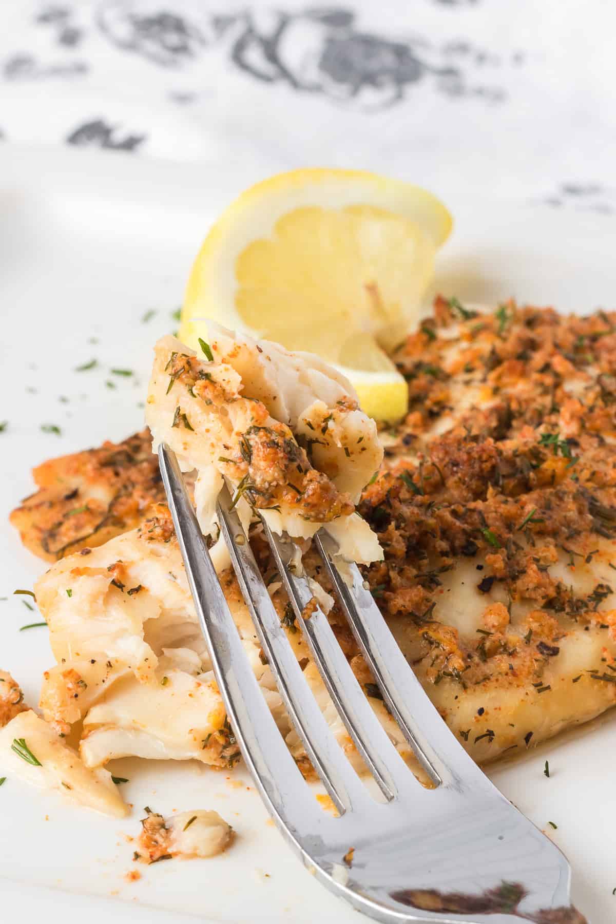 A bite of steamed fish, seasoned tilapia.