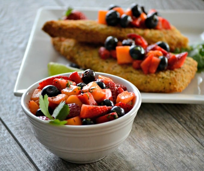 Parmesan crusted Cod accompanied by a fresh strawberry, blueberry and mango salsa - a delicious and easy dinner that's ready in under 30 minutes!