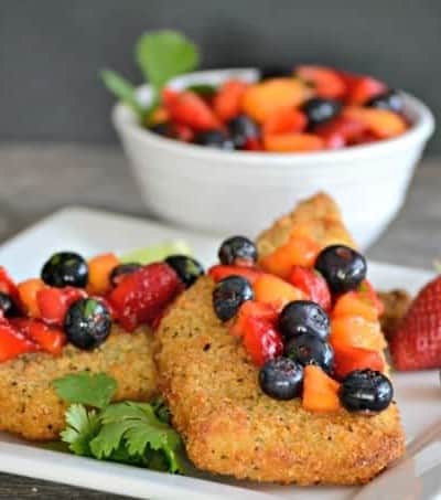 Parmesan crusted Cod accompanied by a fresh strawberry, blueberry and mango salsa - a delicious and easy dinner that's ready in under 30 minutes!